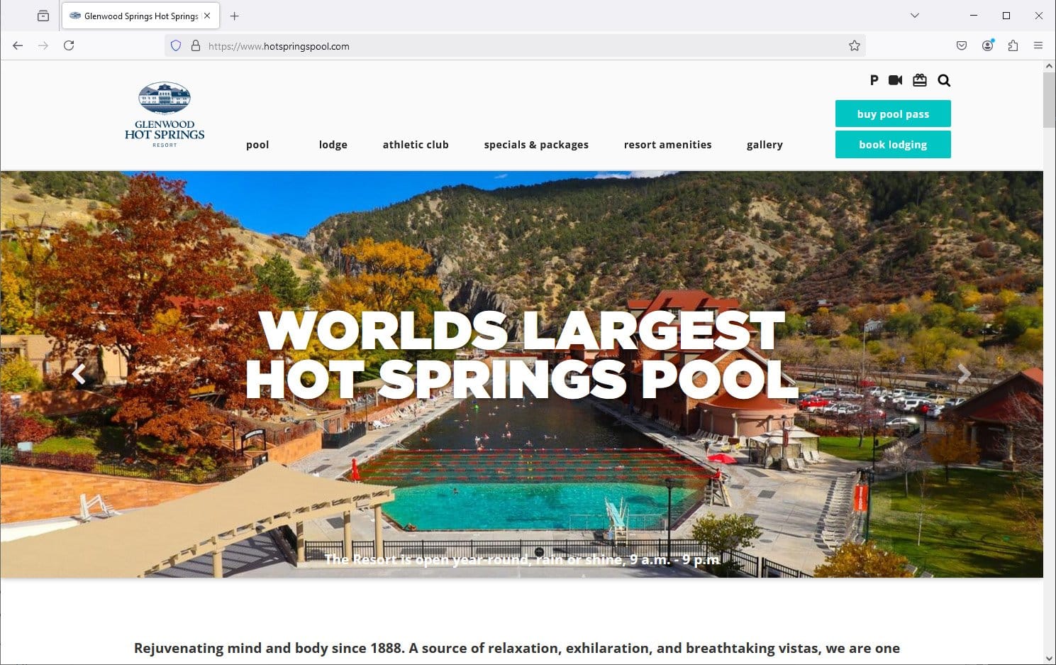 The Glenwood Hot Springs Resort website homepage, with the historic pool photographed at dusk.